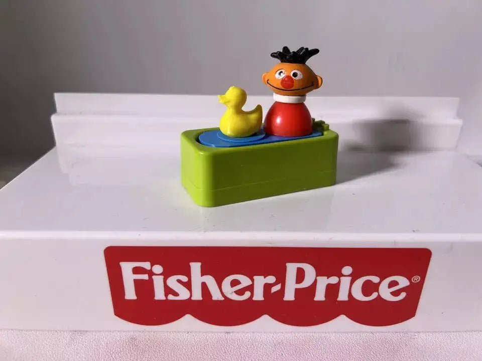 A custom Fisher-Price Little People Ernie figure with a rubber duck toy in a green bath water insert.