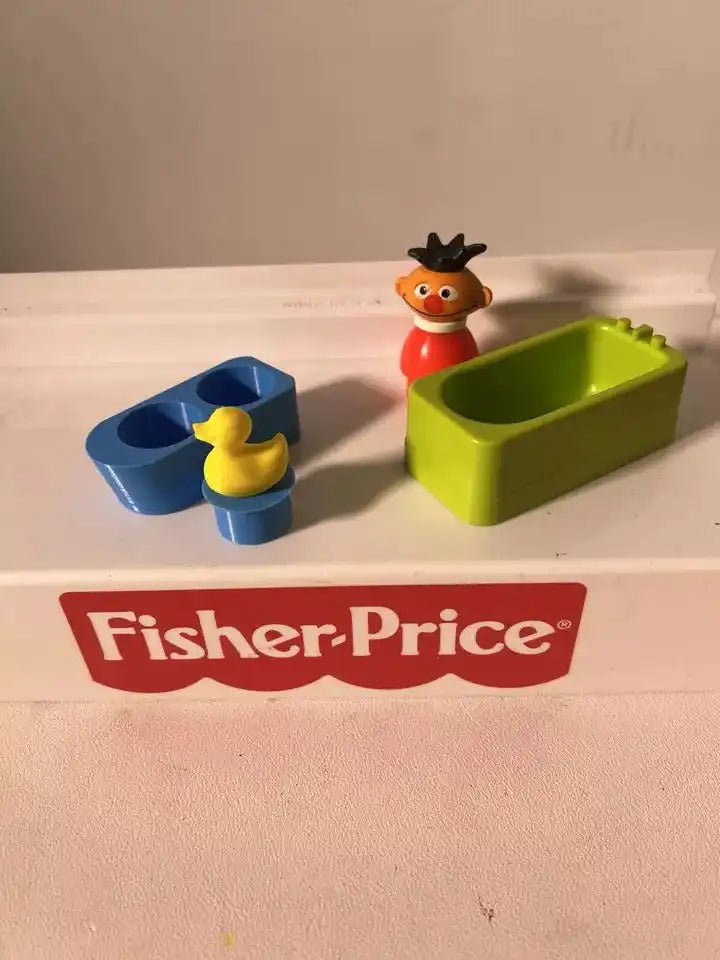 Green and blue water play insert with small yellow rubber duck toy