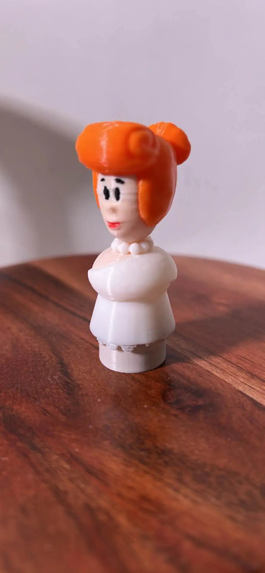 Flintstones Wilma figurine with orange bob hair and white dress, standing on a base