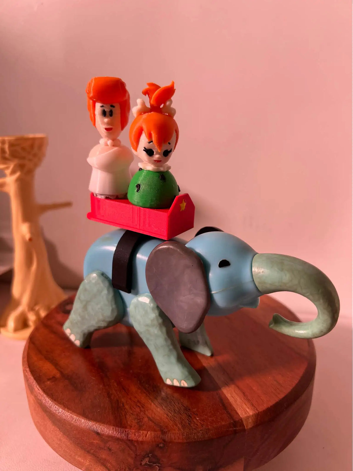 Flintstones Wilma figurine with orange hair and white dress, on a small red base