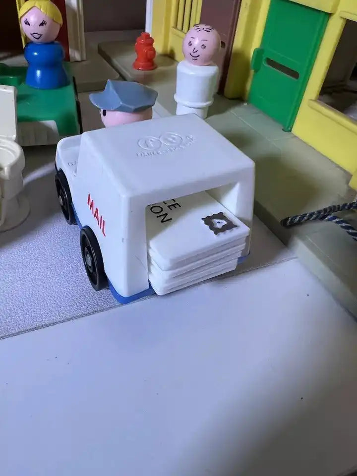 White Fisher Price Little People mail truck with stacked mail and side decals