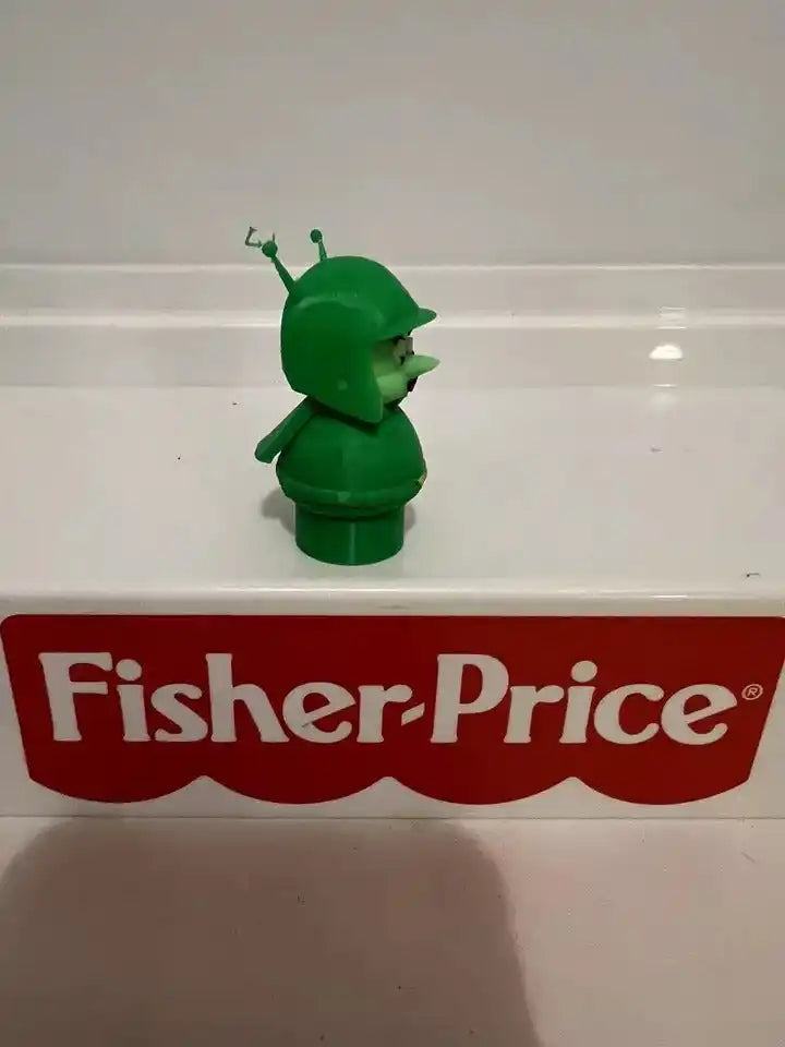 Green Great Gazoo character figure with small antennae, side view, toy